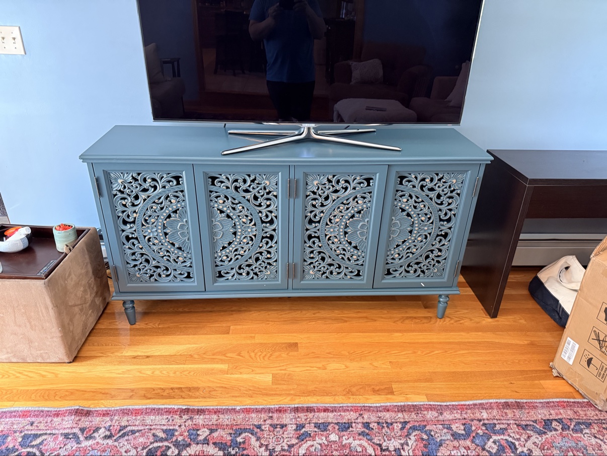 TV console stand assembled with TV mounted above